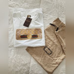 White t-shirt with dust bag.